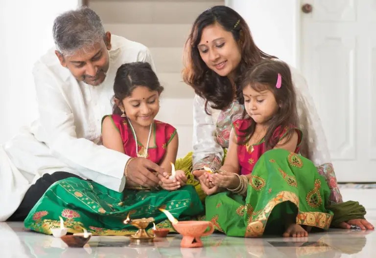 Indian families celebrating Diwali with diyas, rangoli and Lakshmi Puja decorations.
