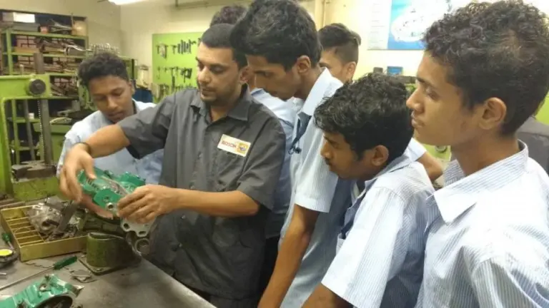 Vocational instructors teaching practical technical and skill-based education in Goa schools.